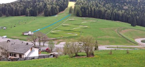 a hill with a winding road in a field at Wuthering Heights in Angolo Terme