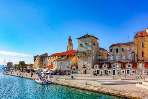a group of buildings next to a body of water at Villa Ana with a private pool on a 3000m2 property in Čvrljevo
