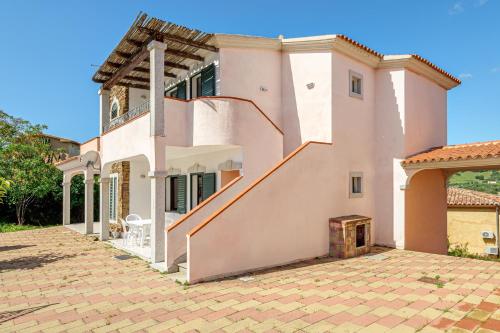 a house with a staircase in front of it at Limpiddu in Limpiddu