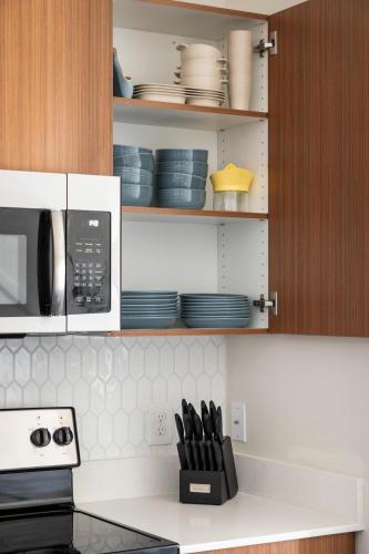 a kitchen with a counter with plates and a microwave at Sleepy Bear Retreat in Traverse City