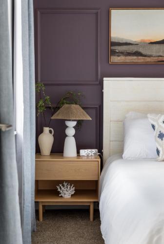 a bedroom with a bed and a table with a lamp at Sleepy Bear Retreat in Traverse City