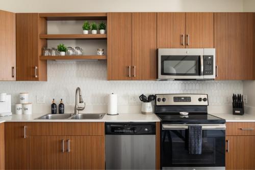 a kitchen with a stove and a microwave at Sleepy Bear Retreat in Traverse City