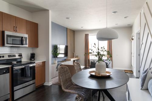 a kitchen and living room with a table and chairs at Sleepy Bear Retreat in Traverse City
