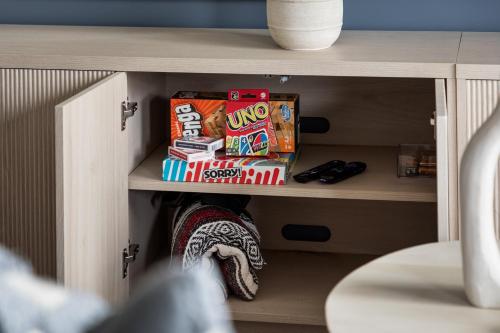 a shelf of a cabinet with snacks on it at Sleepy Bear Retreat in Traverse City
