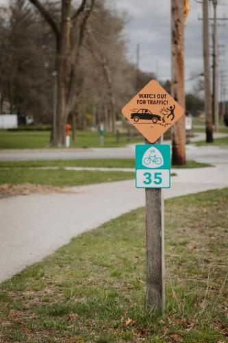 a sign that says travel only for yourself and a bike at Sleepy Bear Retreat in Traverse City