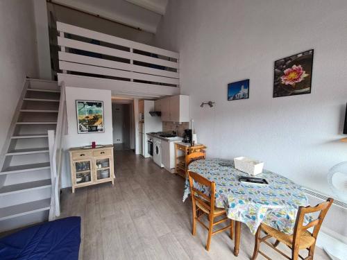 une cuisine et une salle à manger avec une table et un escalier dans l'établissement Appartement T2+Mezzanine 6 pers, Piscine, Parking, à 300m de la Plage - Argelès-sur-Mer - FR-1-388-224, à Argelès-sur-Mer