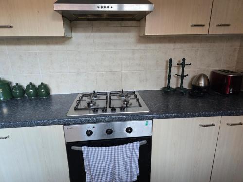 a kitchen with a stove and a sink at Realwood Homes- Birrell Road in Nottingham