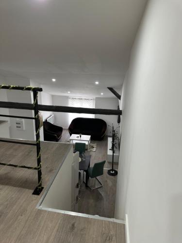 a living room with a couch and a table at Le nid du 4 in Épernay