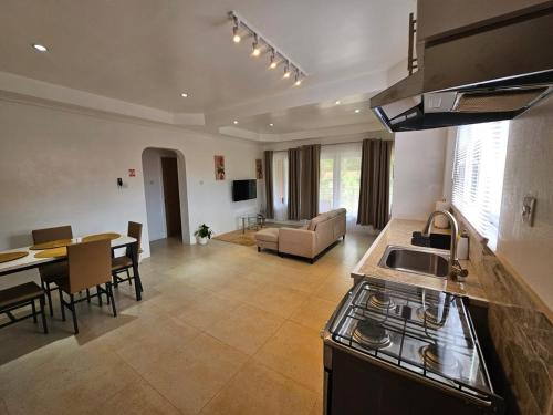 a kitchen and living room with a couch and a table at Agape Suites-Room 4- 1st Floor in Soufrière