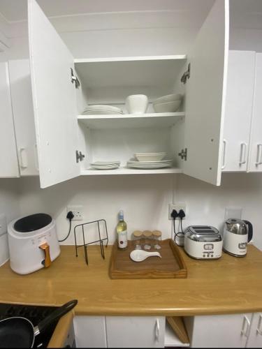 a kitchen with white cabinets and a counter top at Shearwater on Sea 106 in Sedgefield
