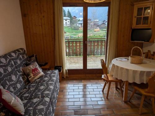 un salon avec une table et un canapé dans l'établissement Appartement cosy pour 5 pers avec parking à Châtel - FR-1-676-211, à Châtel