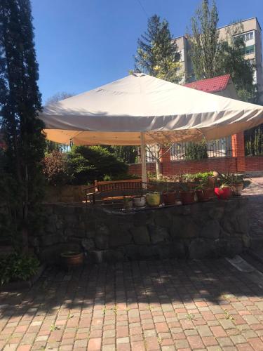 a large white umbrella sitting on a stone wall at Red Stone in Truskavets