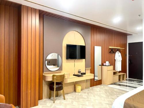 a hotel room with a vanity and a mirror at B.O.B Hotel in Cao Lãnh