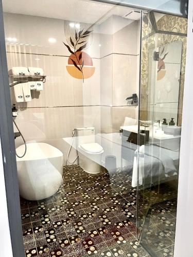 a bathroom with a toilet and a sink at B.O.B Hotel in Cao Lãnh