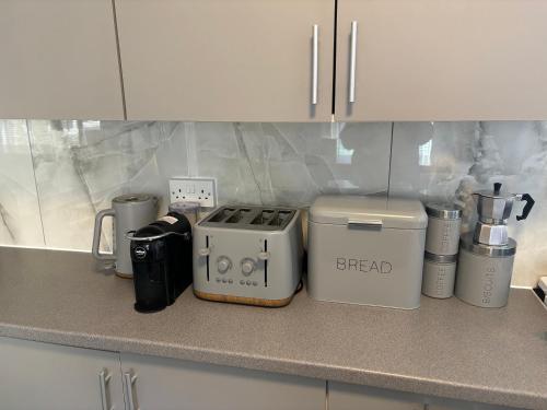 a kitchen counter with appliances on a counter top at Chalkwell Aparthotel Short & Long Stays Welcome, Leisure , Relocation , Business Stays , Contractors in Kent
