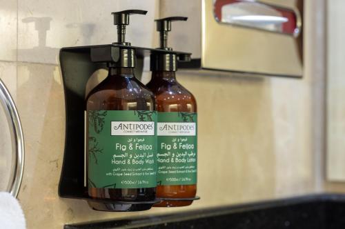 two bottles of sauce on a counter next to a sink at Crowne Plaza Amman by IHG in Amman