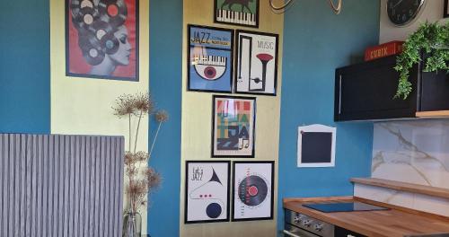 a wall with framed pictures on a wall at The Lake House in Viverone