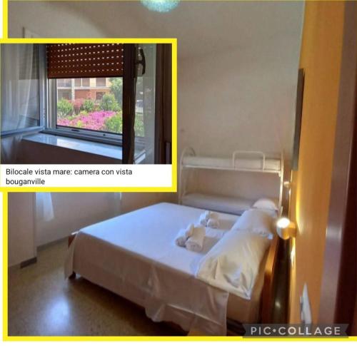 マリーナ・ディ・カメロータにあるCialoma Full Greenの窓のある部屋のベッド