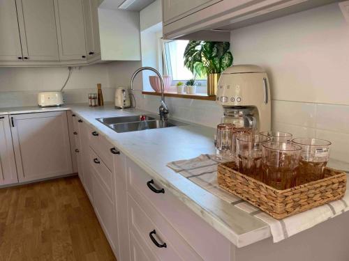 a kitchen with a counter with glasses on it at villa near Åda golf in Trosa