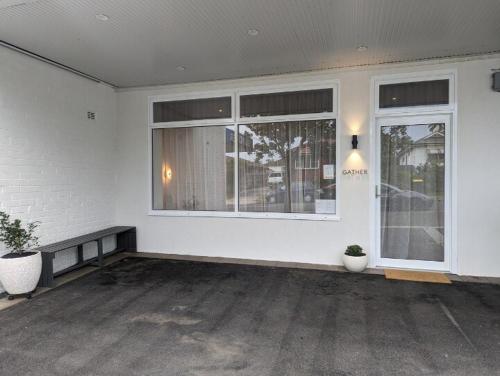 a white room with a large window and a bench at Coastal 3 bedroom duplex Everything at your doorstep in Towradgi