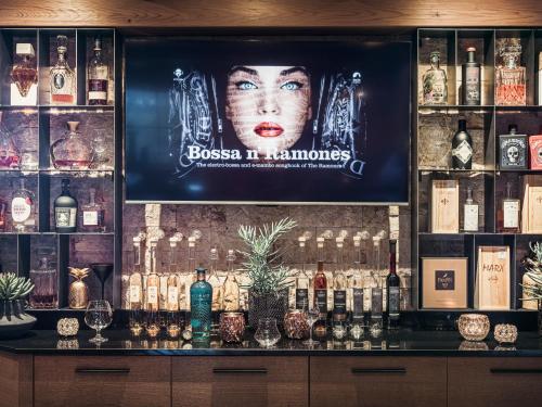 a bar with a large television on the wall at Hotel Bergkristall Zillertal - Adults Only in Hippach