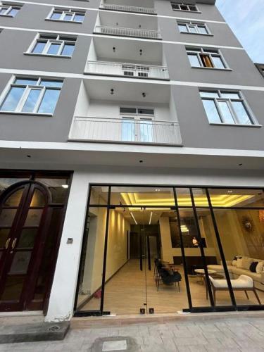 a large building with glass doors and a balcony at Hotel INTERnazionale in Ayacucho