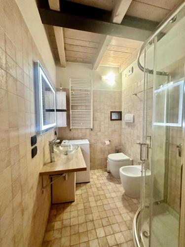 a bathroom with a sink and a toilet and a shower at Le STELLE SULL'ARENA in Verona