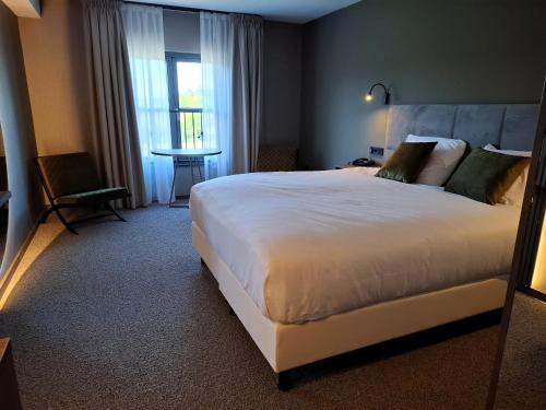 Una cama o camas en una habitación de Hotel Asteria