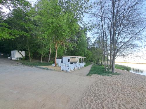 a group of white tents on the side of a river at Słoneczny Zakątek nad Narwią in Serock