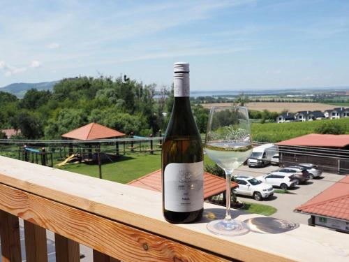 a bottle of wine and a glass on a balcony at Resort Zajíci ze Zaječí in Zaječí