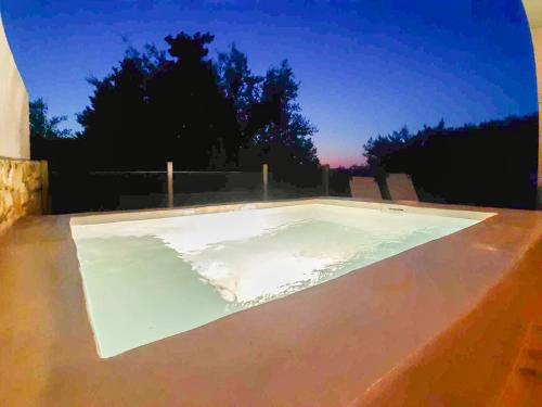 a swimming pool on the roof of a house at Bask in the Beauty of Paxoi - Kirki's Summer Retreats with Private Jacuzzis in Ieromónachos