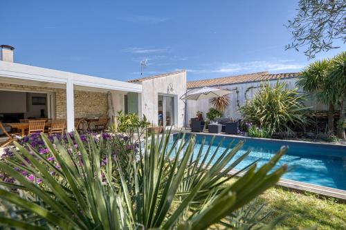 une maison avec une piscine dans une cour dans l'établissement 339 - La Balinaise - Villa with pool, à Sainte-Marie de Ré