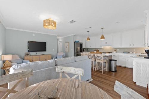 a living room with a couch and a kitchen at Pet Friendly Beach House - Hakuna Matata by Panhandle Getaways in Port Saint Joe