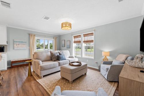 a living room with two couches and a table at Pet Friendly Beach House - Hakuna Matata by Panhandle Getaways in Port Saint Joe