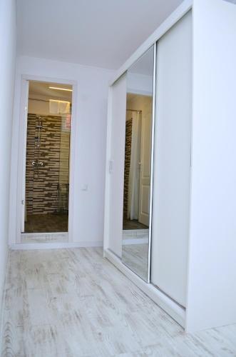 a row of mirrors in a room with white walls at Mid Centro Residence, Self check in & out in Oradea