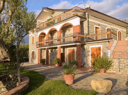 a large house with a balcony on top of it at Il Giardino dei Filosofi in Ascea