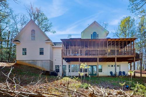 a house with a large deck on top of it at Hilltop Hideaway in Hiawassee