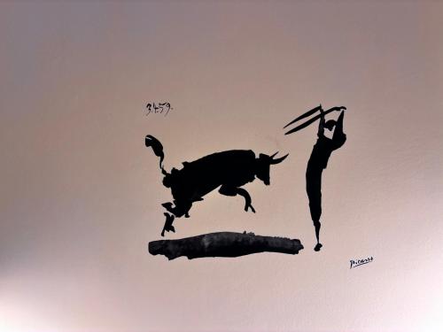 a silhouette of a bull and a man in the sky at Maison de Maff in Pesaro