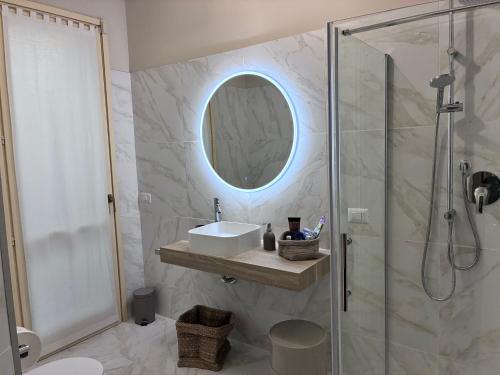 a bathroom with a shower and a sink and a mirror at Maison de Maff in Pesaro