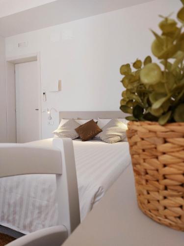 a bedroom with a bed with a potted plant on it at Affittacamere Casa Lilibet in San Benedetto del Tronto