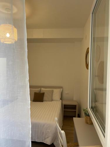 a small bedroom with a bed and a window at Affittacamere Casa Lilibet in San Benedetto del Tronto