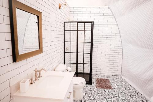a white bathroom with a sink and a toilet at Glamping Dome, Deck Cedar Hot Tub, Mountain View in Eureka Springs