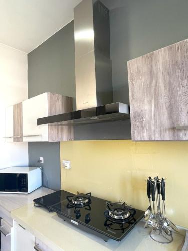 a kitchen with a stove top oven in a kitchen at Appartement avec Rooftop privé et Jacuzzi in Albion