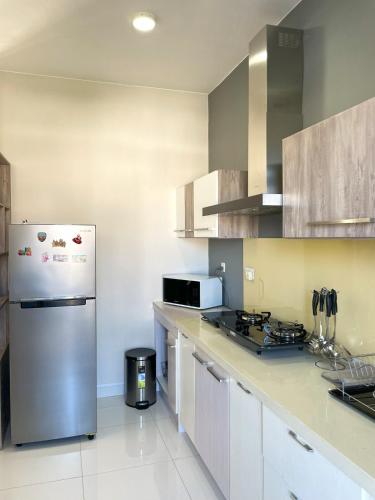a kitchen with a stainless steel refrigerator and cabinets at Appartement avec Rooftop privé et Jacuzzi in Albion