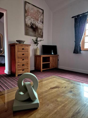 a living room with a chair on the floor at The Badger Inn in Church Minshull