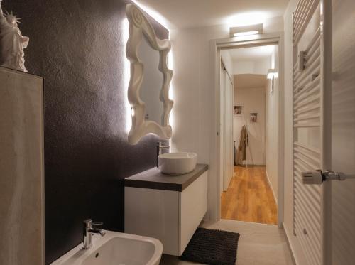 a bathroom with a sink and a white sink at Colombo Lodge Fvg in Tolmezzo