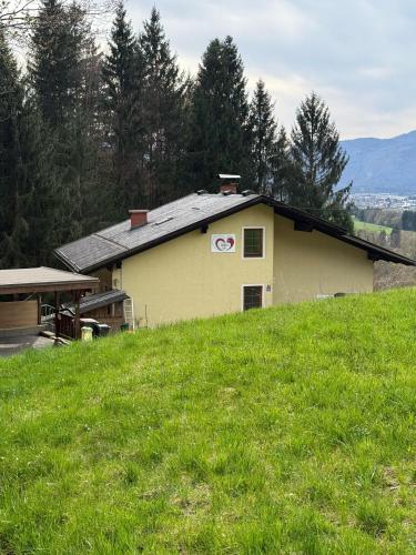 a house on top of a grassy hill at Fridas Place - DER Blick über ganz Villach - 160 m2 Ferienoase - ganzes Haus bis zu 8 Personen in Villach