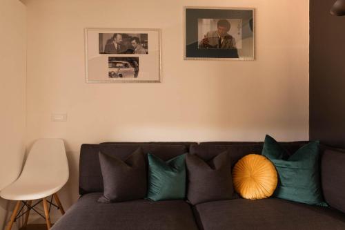 a living room with a couch and two pictures on the wall at Colombo Lodge Fvg in Tolmezzo