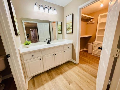 a bathroom with a sink and a large mirror at Eastgate 18A beautiful townhouse in Hammond