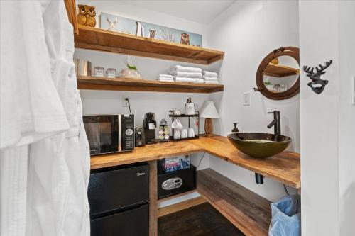 a kitchen with a sink and a counter with a microwave at Green Acres Retreat in Hancock